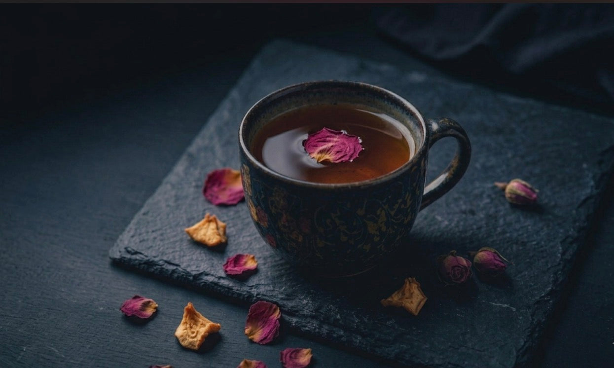Mug of amber peach tea with a floating rose petal — Zero Chaos Coffee Ember Peach